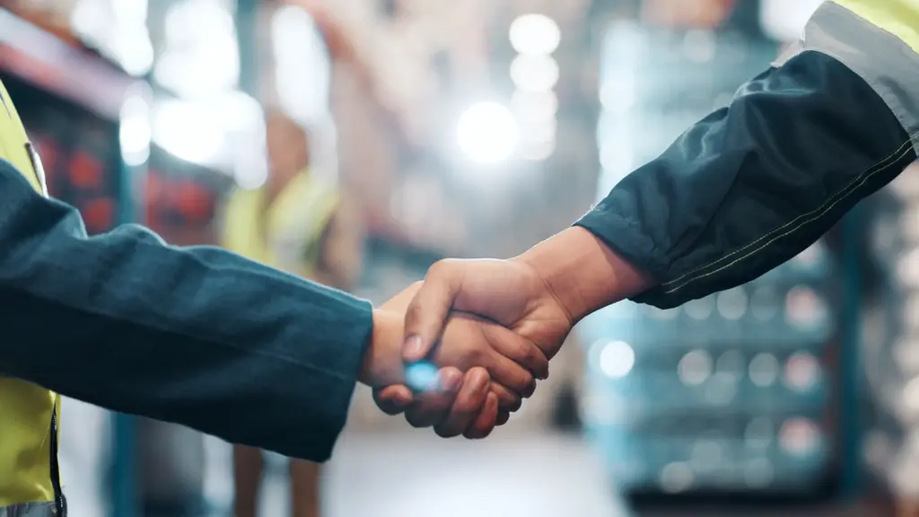 Two union workers shaking hands.