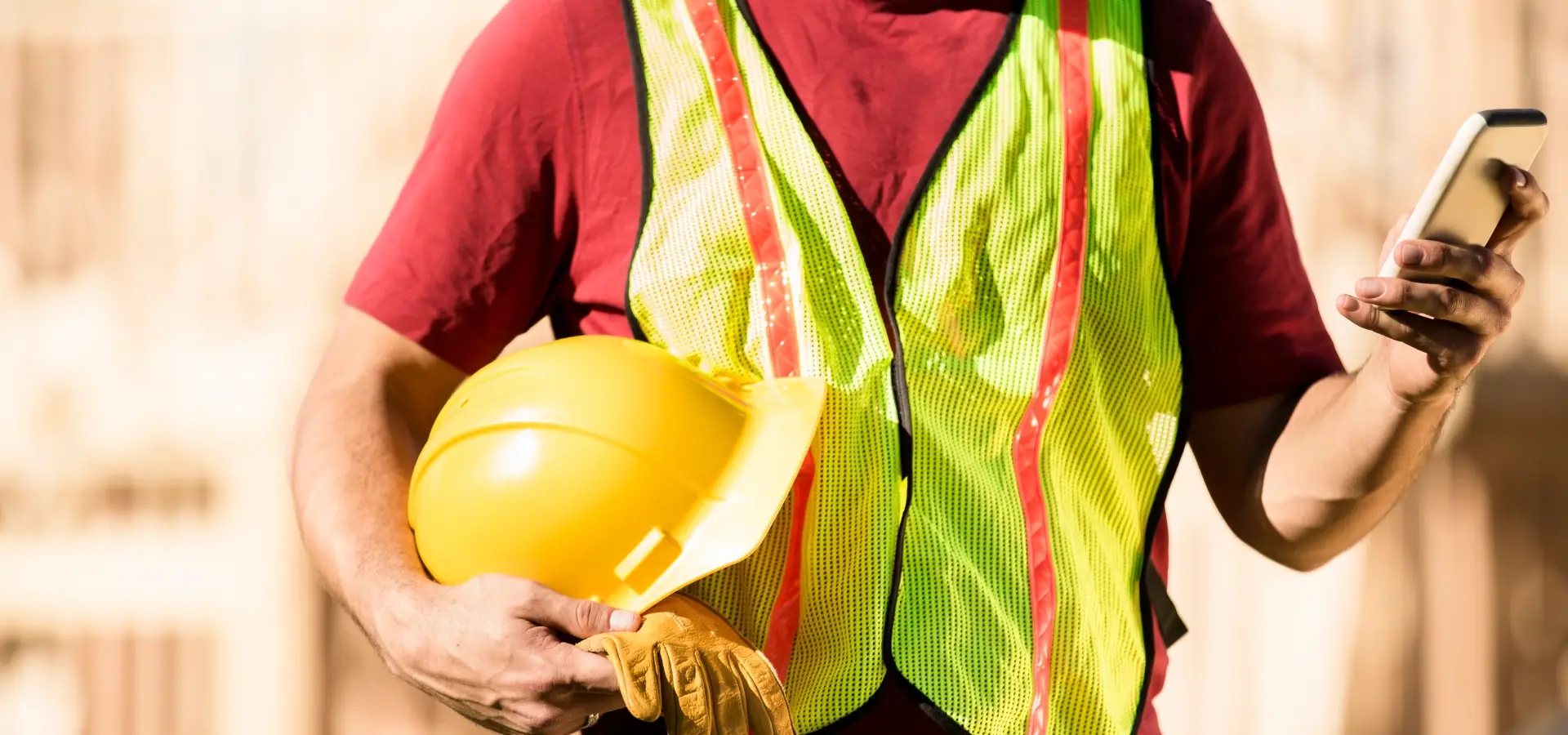 A construction worker looking at his phone.